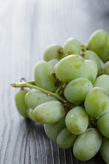 ripe green grapes on black wood table