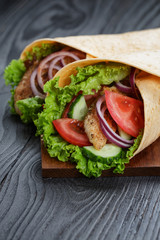 pair of fresh juicy wrap sandwiches with chicken and vegetables