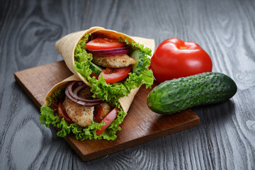 pair of fresh juicy wrap sandwiches with chicken and vegetables