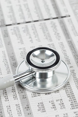 Stethoscope rest on stock price detail financial newspaper