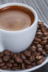 cup of fresh espresso with beans