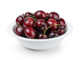 ripe cherries in white bowl