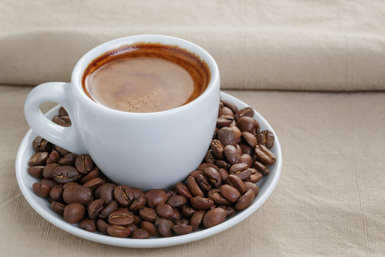 cup of fresh espresso with beans