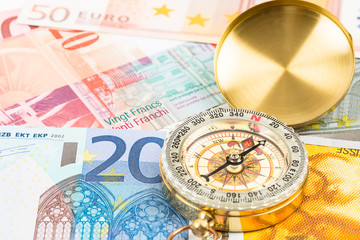 Compass on european banknote concept financial direction