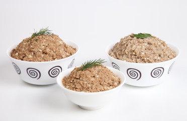 Liver pate in a bowl isolated on white background