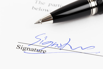 Signature on document with pen