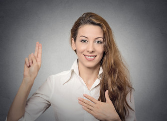 Happy attractive young woman giving a promise smiling 