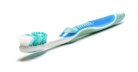 Old dirty used toothbrush isolated on the white background