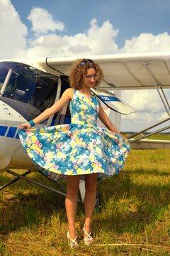 Beautyful Woman In Pinup Style Dress Nearby Ultralight Plane