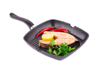 Fried salmon steak on pan.