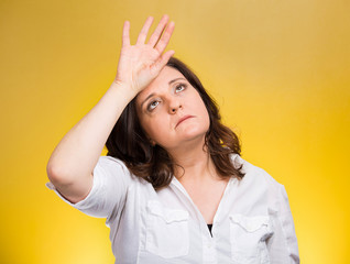 annoyed tired middle aged woman on yellow background 