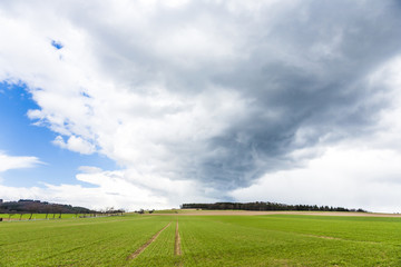 dark clouds over fields in spring