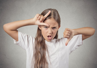 teenager girl showing loser sign giving thumbs down