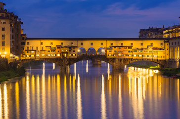 Night view of Ponte Vecchio over Arno River in Florence, Italy