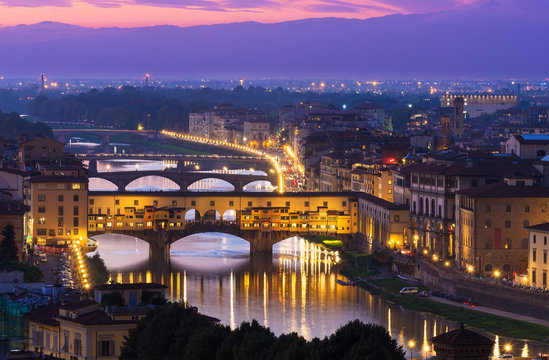 Night view of Ponte Vecchio over Arno River in Florence, Italy