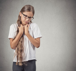 Portrait  shy teenager girl isolated on grey wall background 