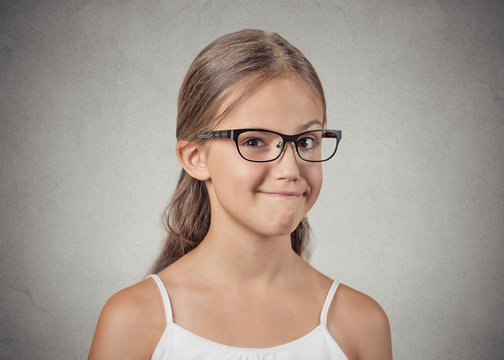 teenager girl with glasses looking suspicious, skeptical