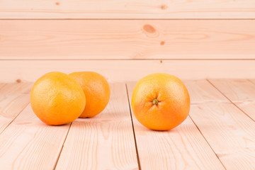 Close up of ripe oranges on wood table.