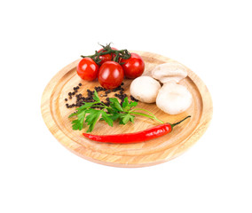 Vegetables on wooden platter.