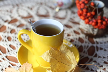 Autumn (fall) cup of tea and colorful leaves . Selective focus