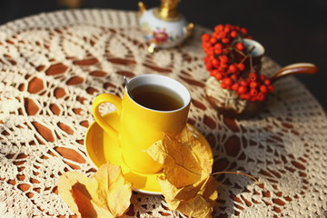 Autumn (fall) cup of tea and colorful leaves . Selective focus