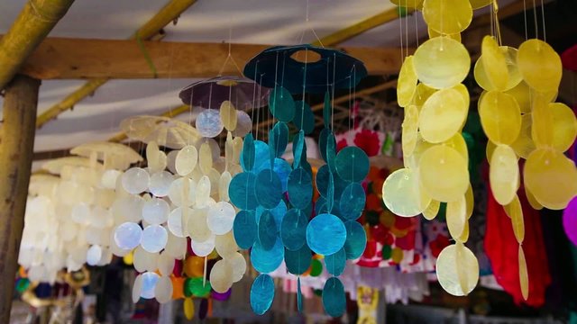 Colorful pendants made of shells swaying in the breeze.