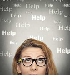 woman with glasses looking up, needs help