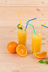 Orange fresh juice on wood table.