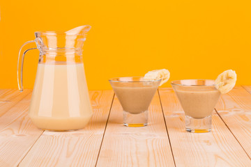Banana smoothie on wood table.