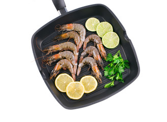 Raw shrimps on frying pan.