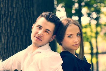 man and woman walking in the park