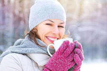 Beautiful happy smiling winter woman with hot drink