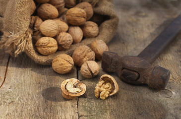 walnuts in burlap bag on old wood table