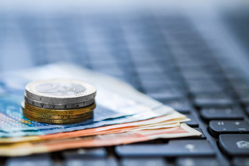 Money on keyboard of computer