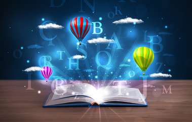 Open book with glowing fantasy abstract clouds and balloons