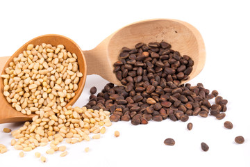 Wooden spoons full with pine nuts.