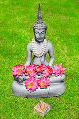 Tempel - Buddhastatue mit Blüten und Räucherstäbchen