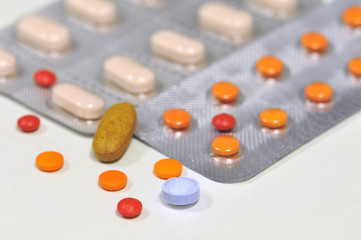 colorful medical therapy with different tablets, and pills