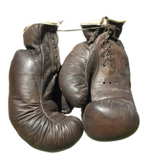 old brown boxing gloves isolated on white background.