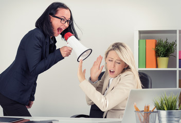 Man boss shouting at employee on megaphone