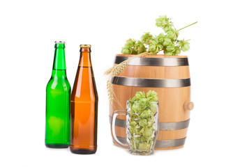 Barrel mug with hops and bottles of beer.