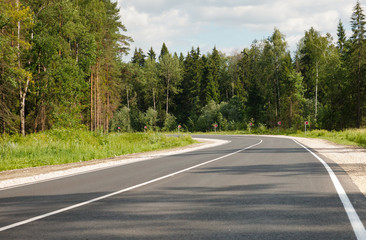  paved road through the forest