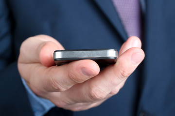 Businessman holding   the  mobile  smart  phone