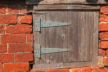 Worn Small Wooden Door set in Old Bricks