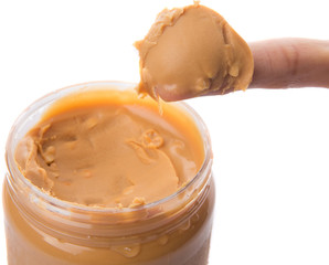 Female finger with peanut butter