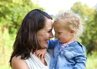 Happy mother and baby smiling face to face