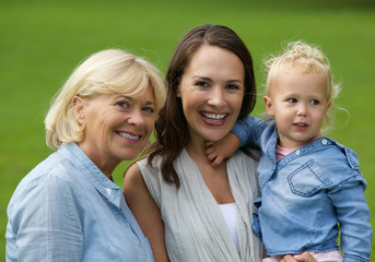 Mother grandmother and baby daughter smiling