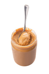 An opened jar of peanut butter with a small spoon