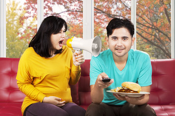 Annoyed woman yelling to her husband