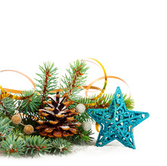 Christmas tree branch with gold serpentine and star on white bac